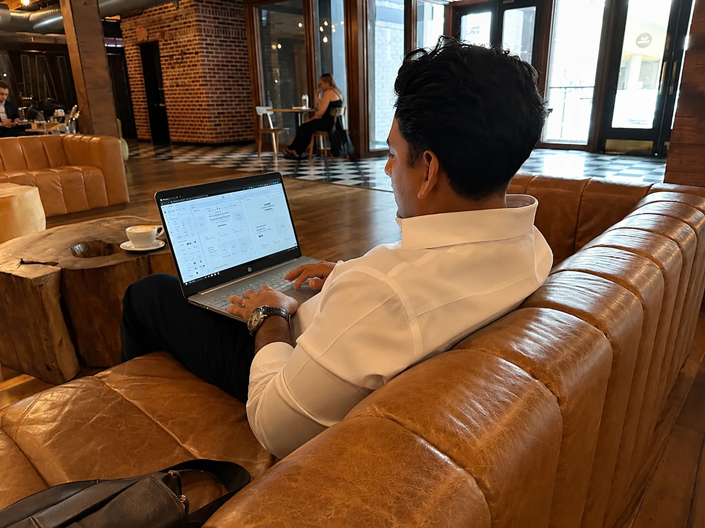 Ed Romero reviewing a website project on a laptop