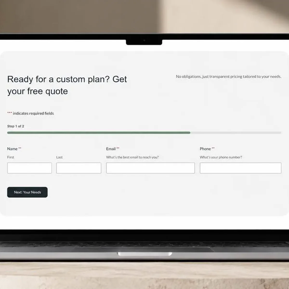 A laptop on a pale stone counter showing a website's quote request form. The headline reads 