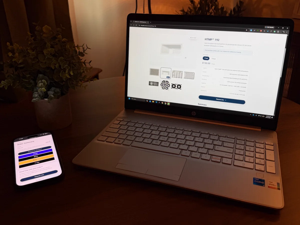 A product page open on a laptop with the checkout open on a phone beside it