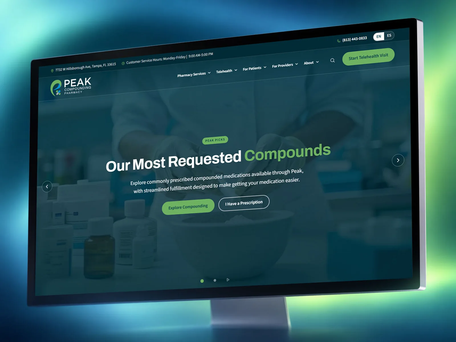 A monitor on a teal and green glow showing the Peak Compounding Pharmacy homepage, headlined Our Most Requested Compounds