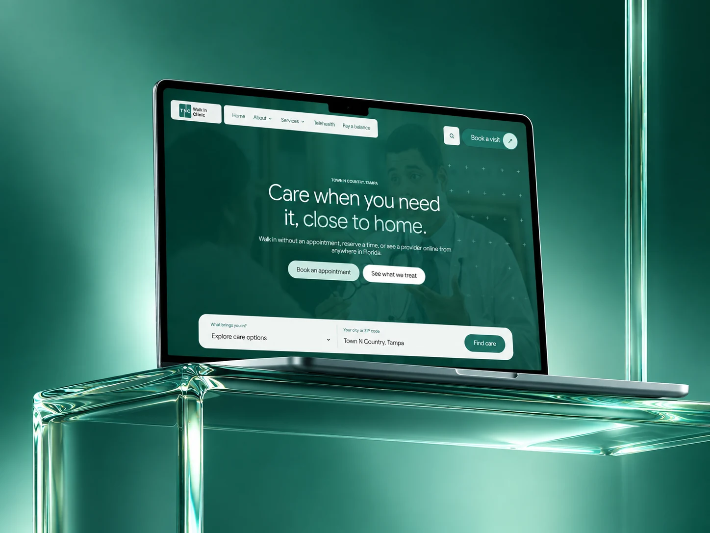 A laptop on a glass plinth in a deep green glow, showing the TNC Walk In Clinic homepage headlined Care when you need it, close to home