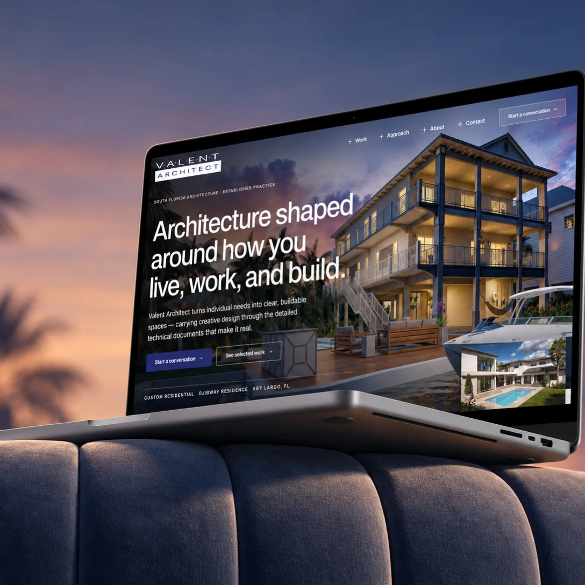 A laptop on the back of a sofa at sunset showing the Valent Architect homepage
