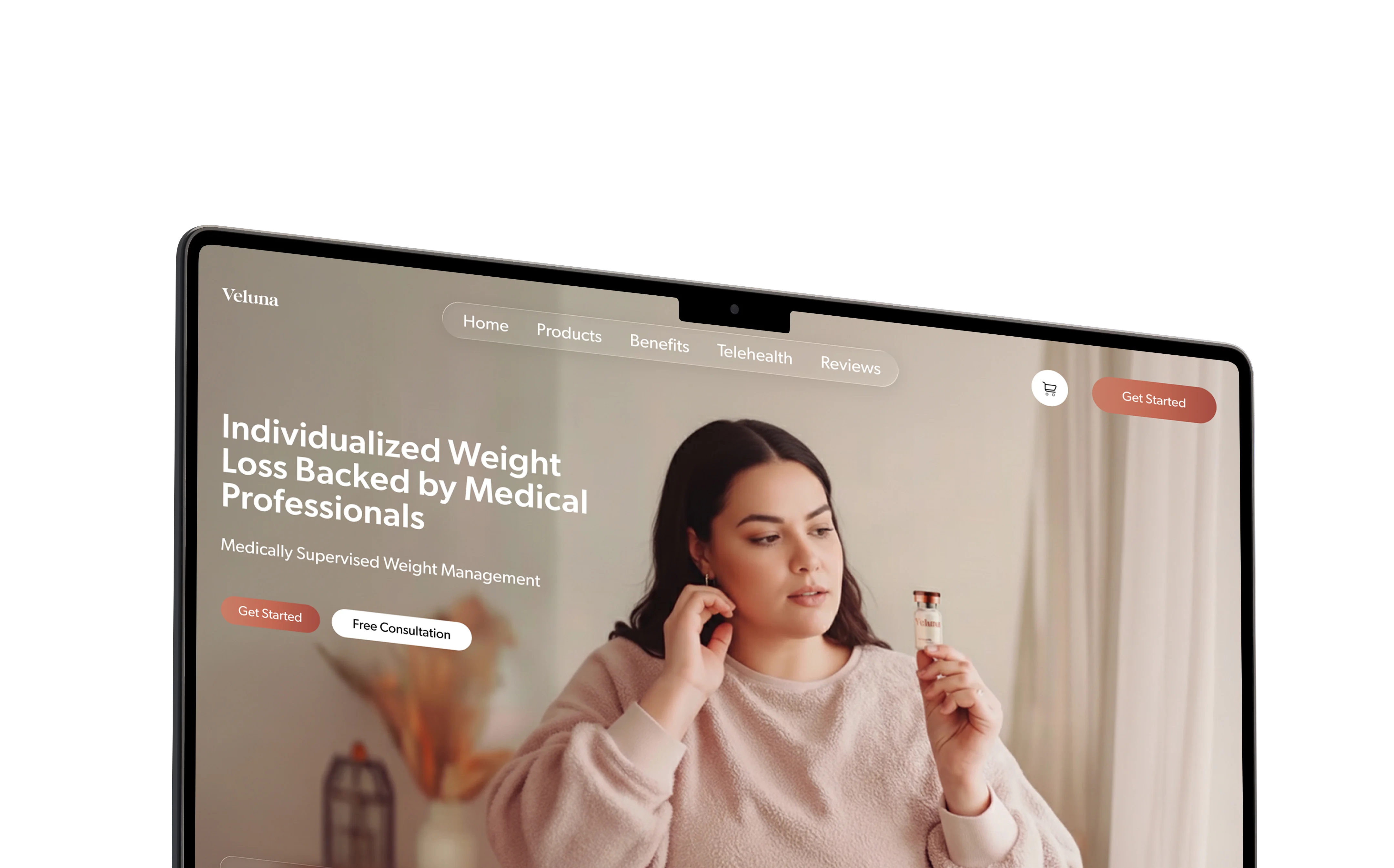 Angled laptop showing the Veluna telehealth weight loss website concept with warm wellness imagery